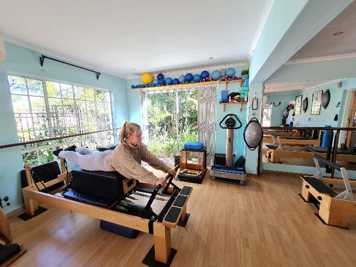 Lady using pilates workout bench