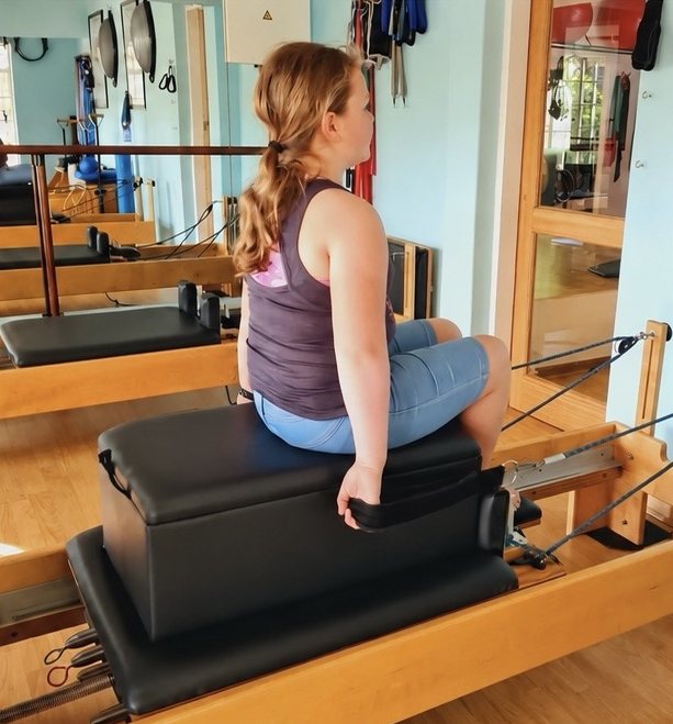 A teenager doing Pilates on the reformer at Pilates Dynamics studio in Randburg